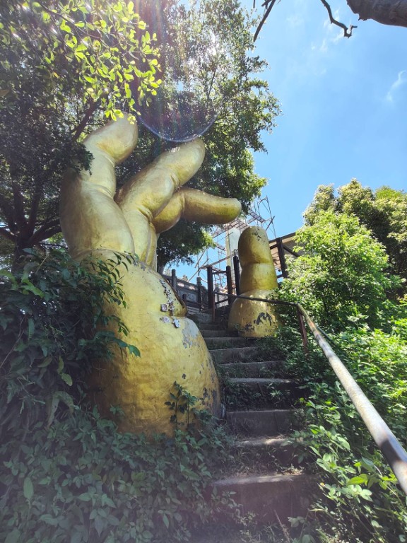 The second Golden Buddha Hand statue, located beside the final summit stairs of Nan Guanyinshan, symbolizing a successful ascent.