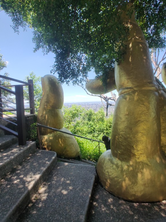 The reward at the summit of Nan Guanyinshan: the iconic Golden Buddha Hand landmark against the sweeping vista of Taichung City.